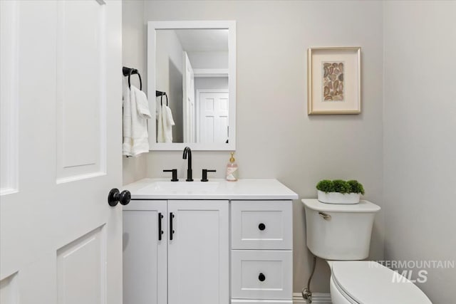 bathroom featuring toilet and vanity