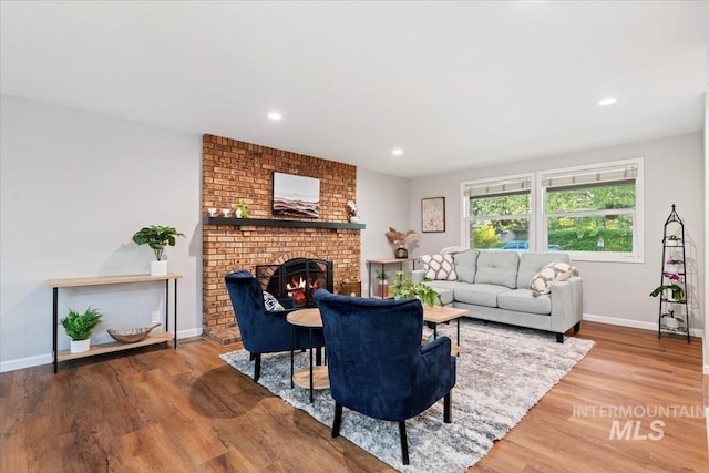 living room with baseboards, recessed lighting, wood finished floors, and a fireplace