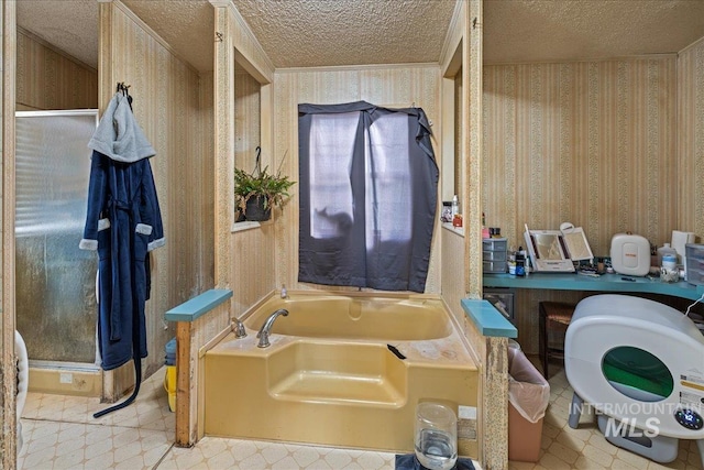 bathroom featuring a textured ceiling and a tub to relax in