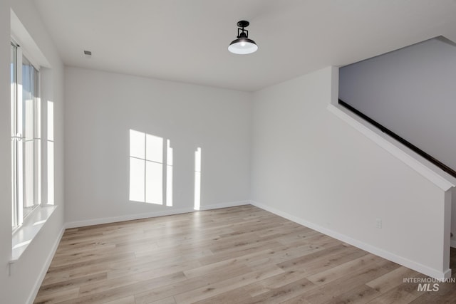 unfurnished room with light wood-type flooring