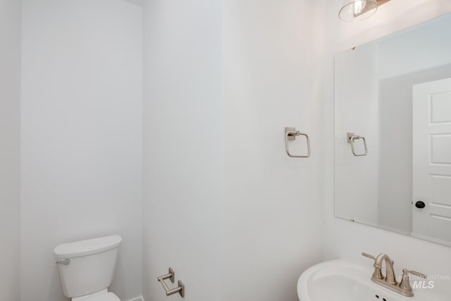 bathroom featuring sink and toilet