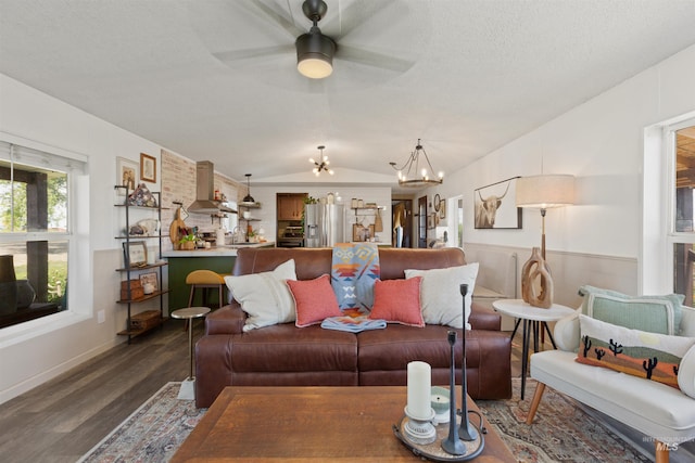 5950 Elmore Rd, New Plymouth, ID 83655 - living room with a chandelier, dark wood-style floors, vaulted ceiling, ceiling fan, and baseboards
