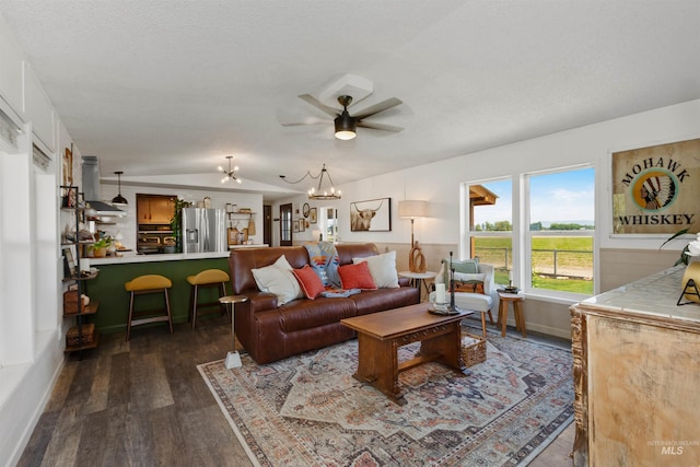 5950 Elmore Rd, New Plymouth, ID 83655 - living area with ceiling fan, dark wood-style flooring, a chandelier, and vaulted ceiling