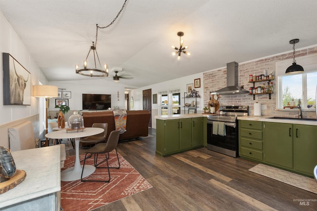 5950 Elmore Rd, New Plymouth, ID 83655 - kitchen with green cabinetry, stainless steel electric range oven, a chandelier, wall chimney range hood, and dark wood-type flooring