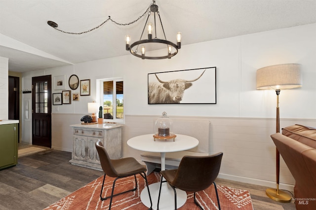 5950 Elmore Rd, New Plymouth, ID 83655 - dining space featuring a chandelier, dark wood-style floors, and a wainscoted wall