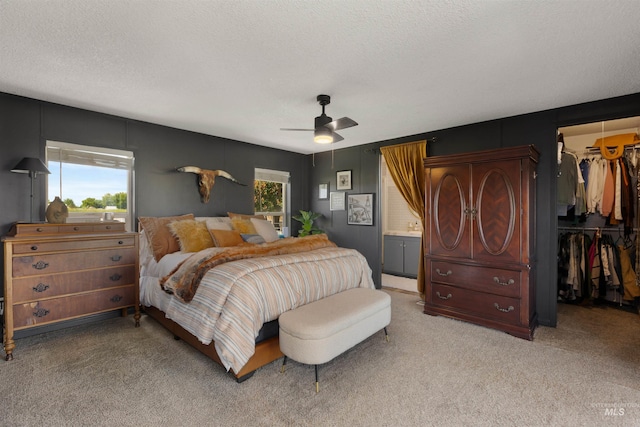 5950 Elmore Rd, New Plymouth, ID 83655 - bedroom with a spacious closet, carpet floors, a closet, a textured ceiling, and ceiling fan