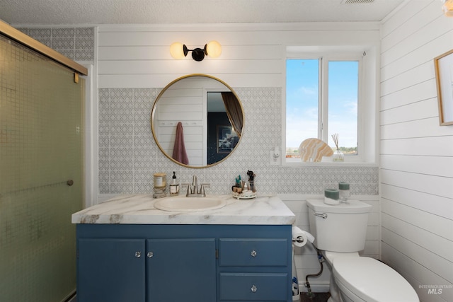 5950 Elmore Rd, New Plymouth, ID 83655 - bathroom with vanity, toilet, an enclosed shower, and wooden walls
