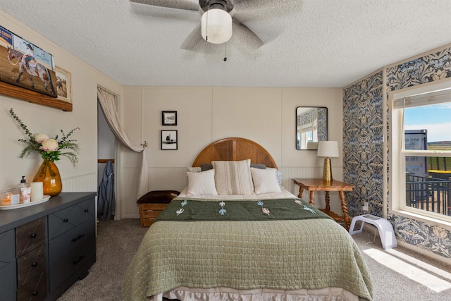 5950 Elmore Rd, New Plymouth, ID 83655 - carpeted bedroom with a textured ceiling, a ceiling fan, and wallpapered walls