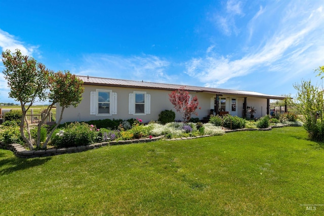 5950 Elmore Rd, New Plymouth, ID 83655 - ranch-style home with stucco siding, a front lawn, a standing seam roof, and metal roof