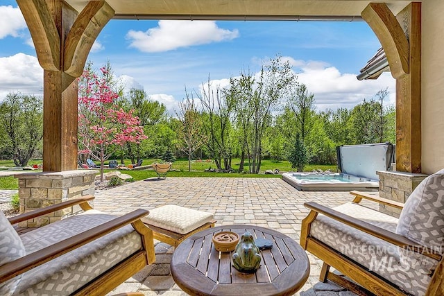 view of patio / terrace featuring a covered hot tub