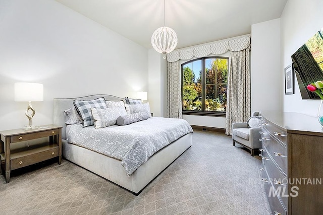 bedroom with an inviting chandelier and carpet flooring