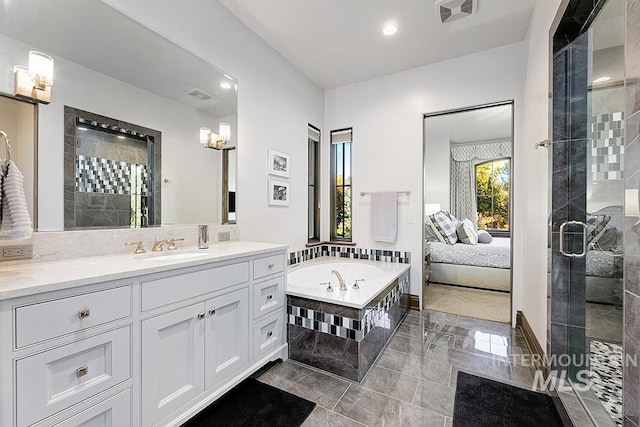 full bathroom with visible vents, a shower stall, and vanity