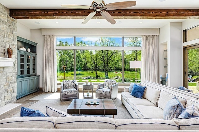 sunroom featuring plenty of natural light and beamed ceiling