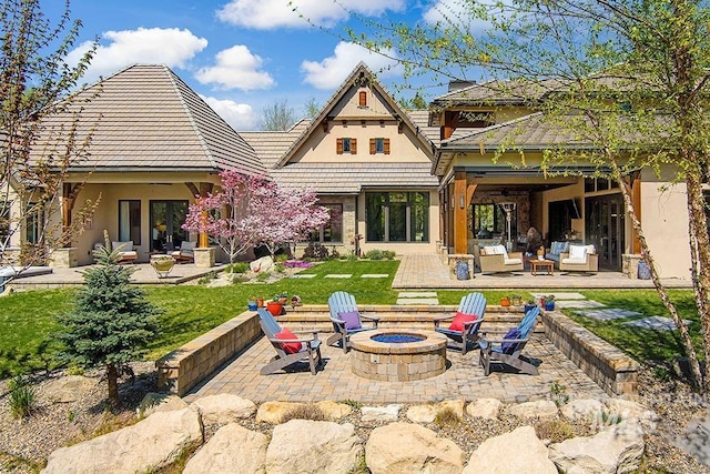 back of house featuring an outdoor living space with a fire pit, a patio, stucco siding, french doors, and a lawn