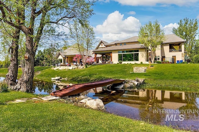 view of dock featuring a lawn