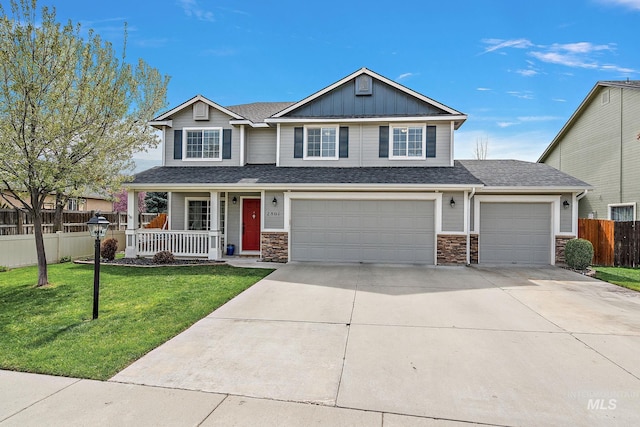 2801 W Lost Rpds, Meridian, ID 83646 - craftsman-style home with a porch, stone siding, fence, concrete driveway, and a front lawn