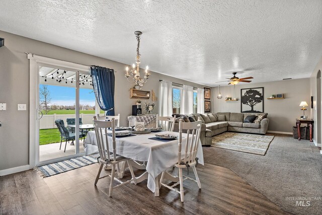 2801 W Lost Rpds, Meridian, ID 83646 - dining space with a textured ceiling, ceiling fan with notable chandelier, wood finished floors, and baseboards