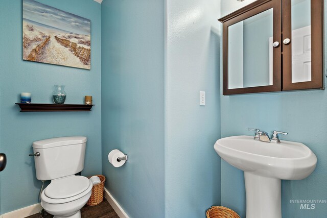 2801 W Lost Rpds, Meridian, ID 83646 - half bathroom featuring toilet, wood finished floors, and baseboards
