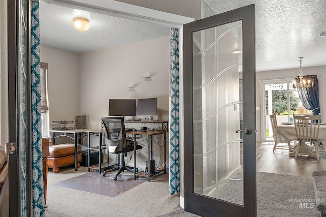 2801 W Lost Rpds, Meridian, ID 83646 - carpeted office space with an inviting chandelier, wood finished floors, and a textured ceiling