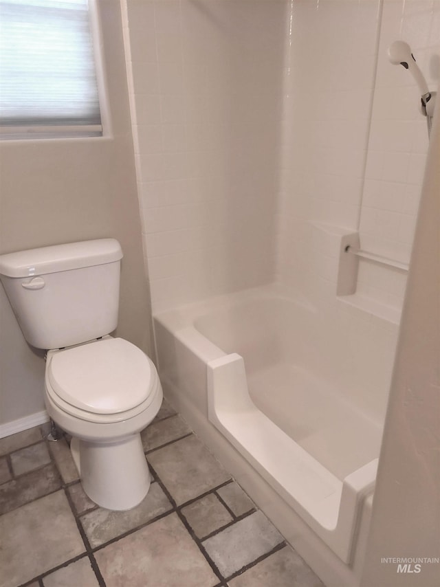 full bathroom featuring bathing tub / shower combination, baseboards, and toilet