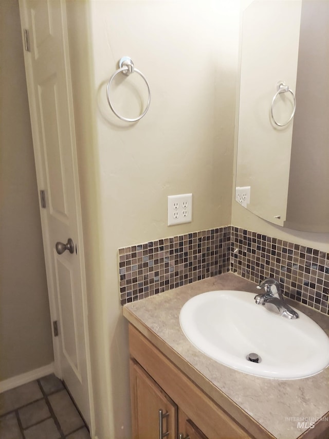 bathroom featuring decorative backsplash, vanity, and tile patterned flooring