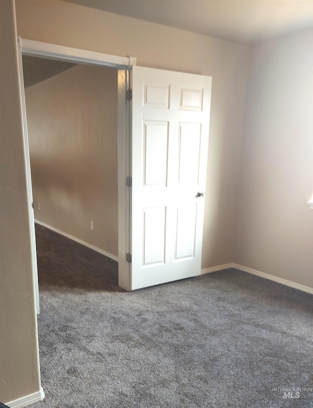 unfurnished bedroom featuring carpet and baseboards
