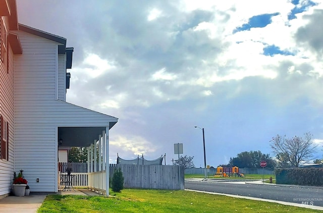 exterior space featuring street lighting, traffic signs, and sidewalks