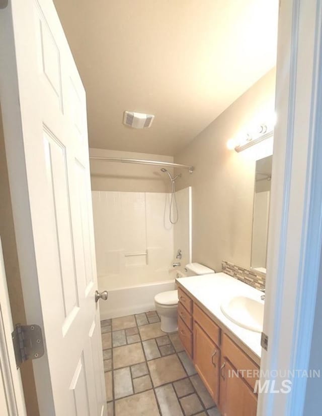 full bath featuring toilet, vanity, visible vents, and bathing tub / shower combination