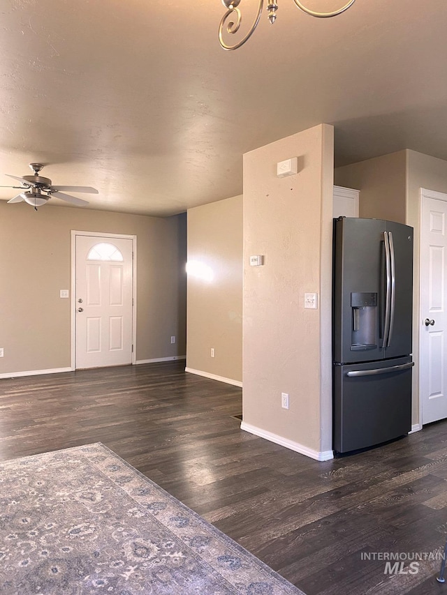 interior space featuring ceiling fan, baseboards, and dark wood-style flooring