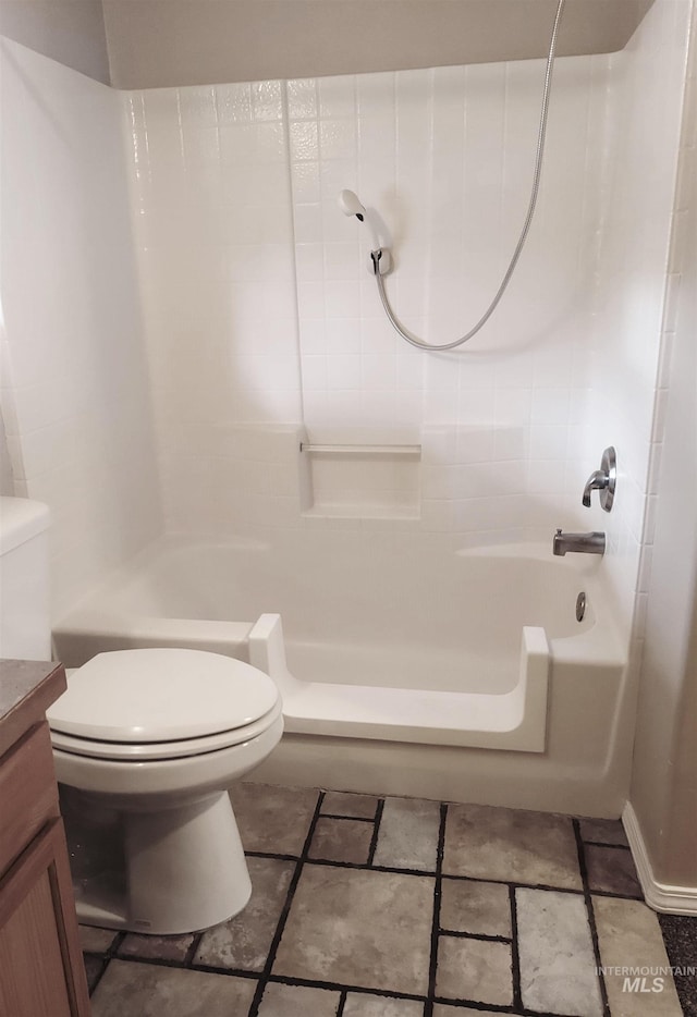 bathroom with tub / shower combination, toilet, and vanity