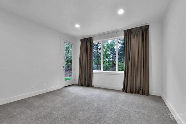 carpeted empty room with baseboards and recessed lighting