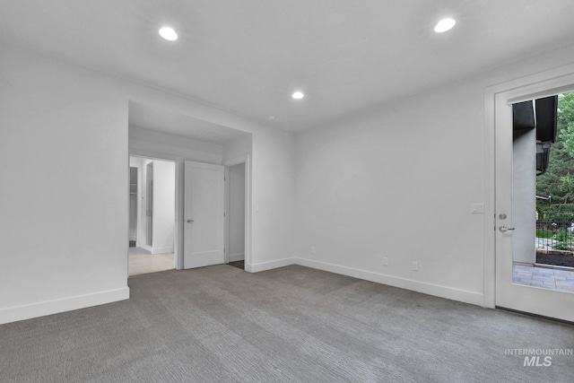 unfurnished room with carpet, recessed lighting, and baseboards