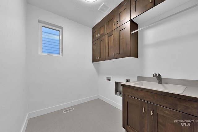 laundry room featuring electric dryer hookup, cabinet space, washer hookup, and baseboards