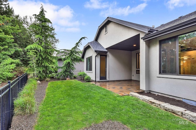 back of property featuring a patio and stucco siding