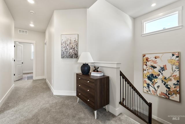 hallway with recessed lighting, carpet floors, an upstairs landing, baseboards, and visible vents