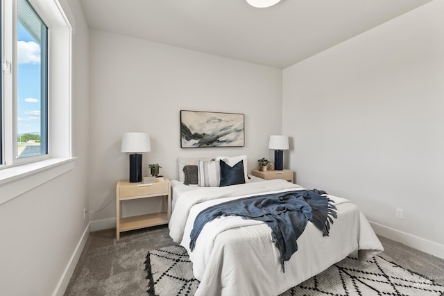 carpeted bedroom featuring baseboards