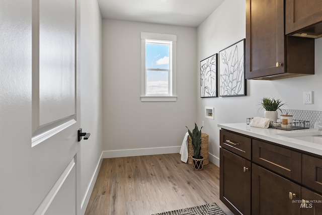 interior space featuring wood finished floors, vanity, and baseboards