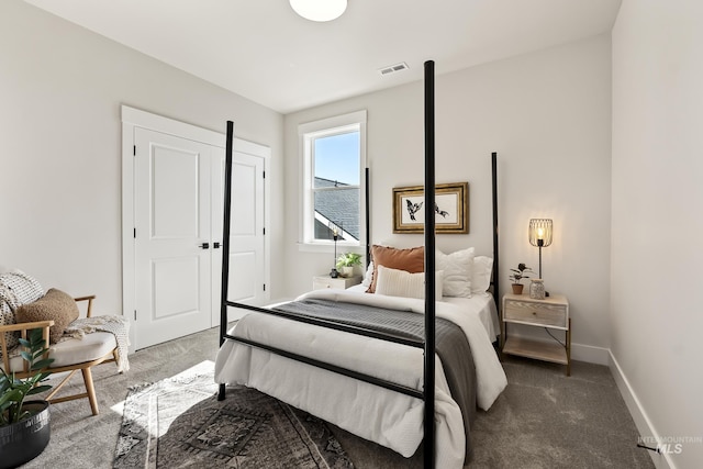 carpeted bedroom with visible vents and baseboards