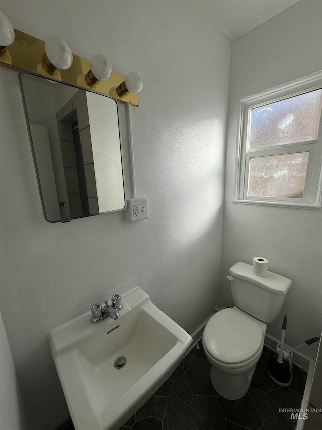 bathroom featuring tile patterned flooring, sink, and toilet