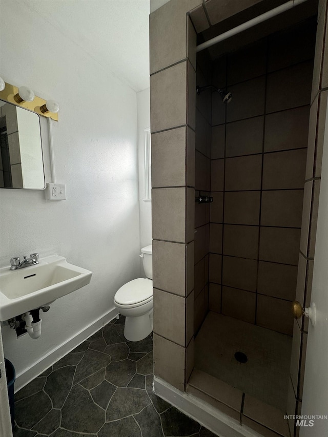 660 SW 2nd St, Ontario, OR 97914 - full bathroom featuring a stall shower, a sink, toilet, tile patterned flooring, and baseboards