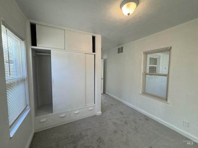 660 SW 2nd St, Ontario, OR 97914 - unfurnished bedroom with carpet flooring, a closet, baseboards, and a textured ceiling