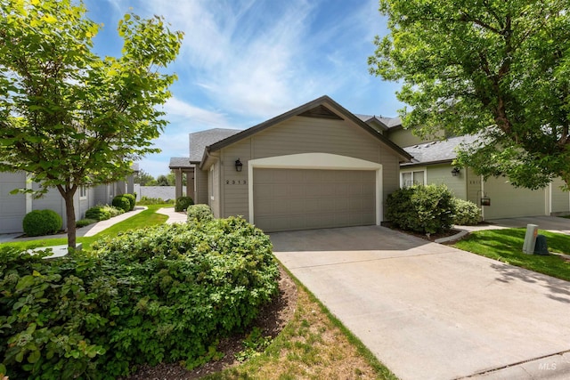 2313 River Oaks Ct, Nampa, ID 83686 - view of front of home featuring driveway, an attached garage, and a shingled roof