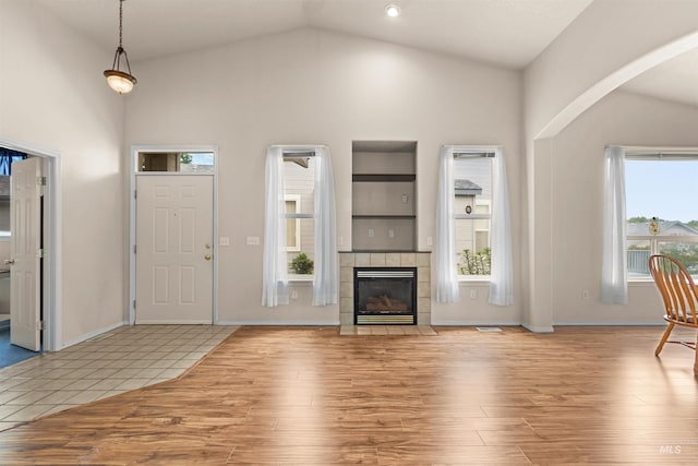 2313 River Oaks Ct, Nampa, ID 83686 - entrance foyer with wood finished floors, high vaulted ceiling, arched walkways, a fireplace, and baseboards