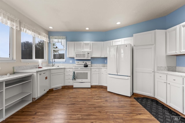 2313 River Oaks Ct, Nampa, ID 83686 - kitchen with white appliances, a sink, white cabinets, dark wood-style floors, and recessed lighting