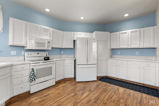 2313 River Oaks Ct, Nampa, ID 83686 - kitchen with white appliances, white cabinetry, dark wood finished floors, light countertops, and recessed lighting