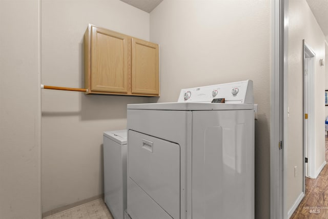 2313 River Oaks Ct, Nampa, ID 83686 - laundry room with cabinet space, baseboards, and light wood finished floors