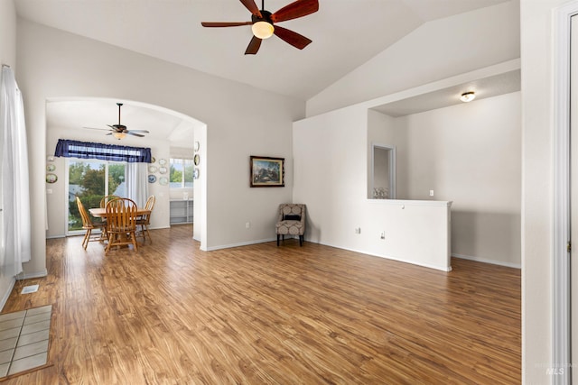 2313 River Oaks Ct, Nampa, ID 83686 - living room with ceiling fan, vaulted ceiling, light wood-style flooring, arched walkways, and baseboards