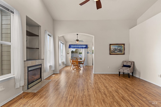 2313 River Oaks Ct, Nampa, ID 83686 - sitting room featuring ceiling fan, arched walkways, light wood-type flooring, and a tiled fireplace