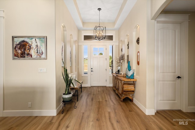 550 W Heikes Ln, Eagle, ID 83616 - entrance foyer featuring wood finished floors, arched walkways, baseboards, and a raised ceiling