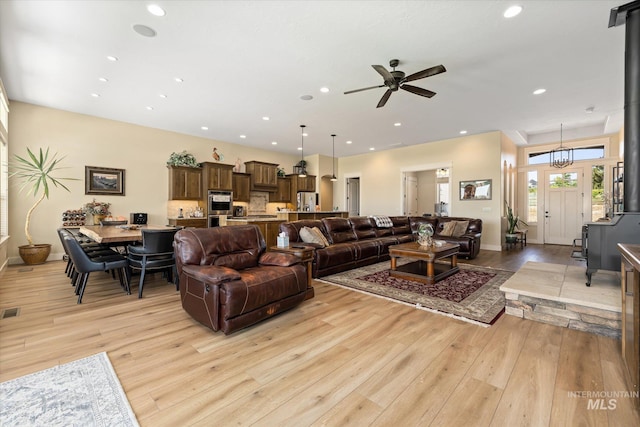 550 W Heikes Ln, Eagle, ID 83616 - living room featuring light wood finished floors, recessed lighting, ceiling fan, and baseboards